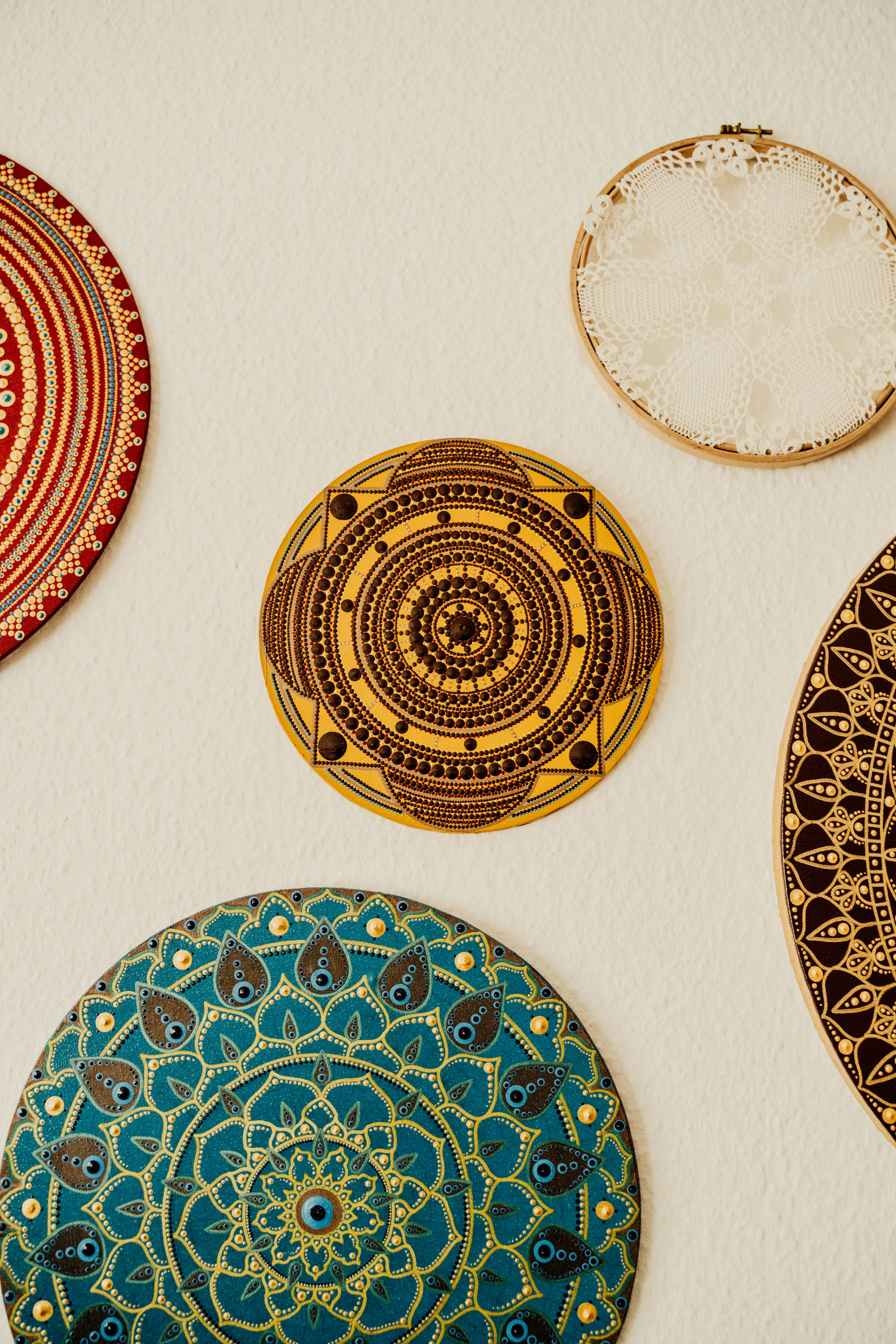 Painted mandala plates on wall.