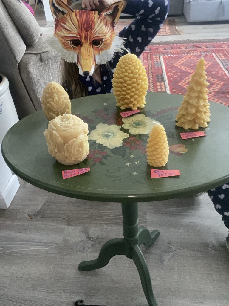 Assorted beeswax candles on table.