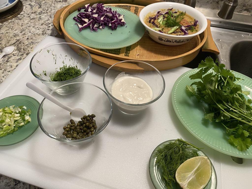 Fresh herbs and ingredients on plates.